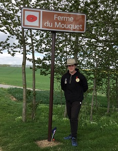 William Scott standing near a sign saying Ferme du Mouquet 