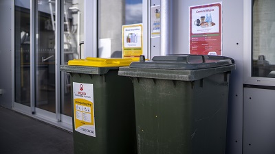 Two large recycling bins with labels