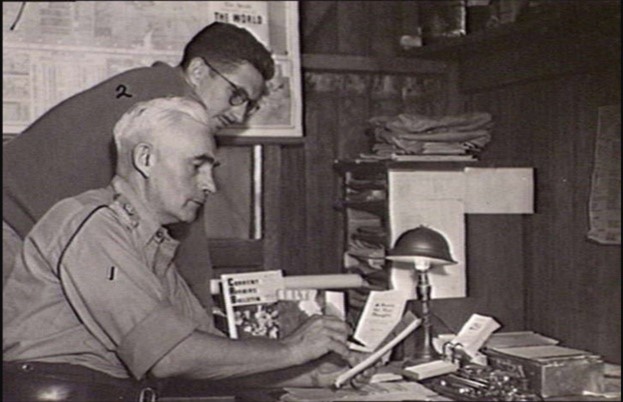 Two men looking at documents on a desk