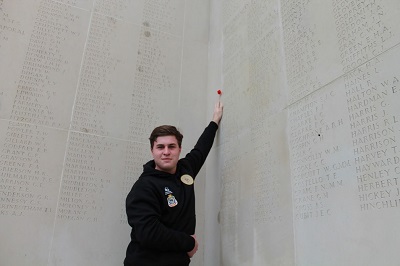 William Scott at a memorial wall containing many inscribed World War One soldiers' names